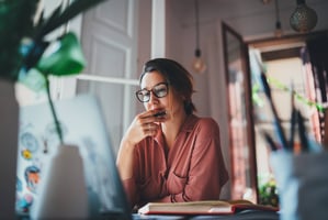 Person working at desk reading guide