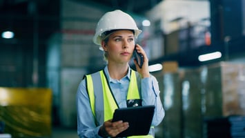 Factory worker using mobile phone