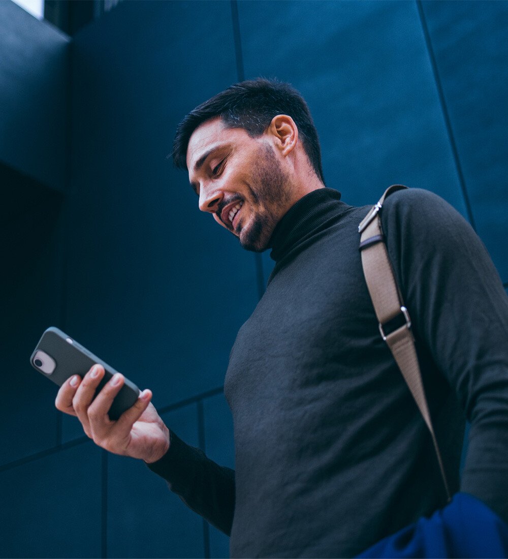 Man on cell phone in front of building