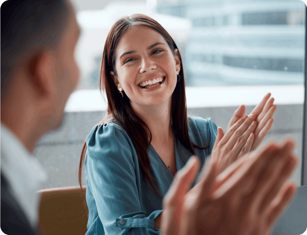 Smiling woman talking to male colleague
