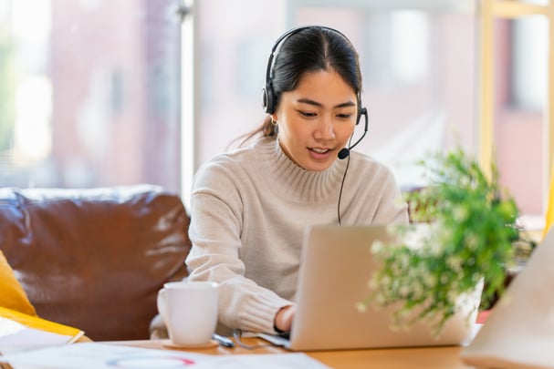 Woman on computer using headset