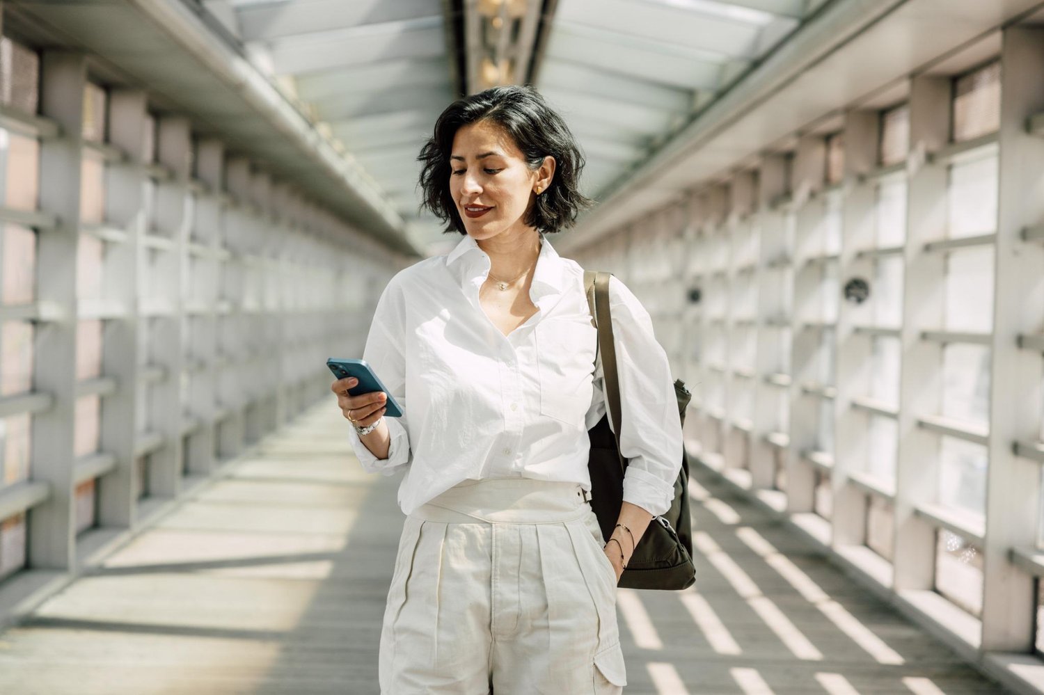 Woman reading her text messages while walking