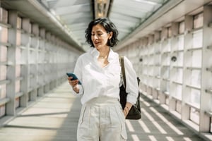 Woman walking and reading her text messages