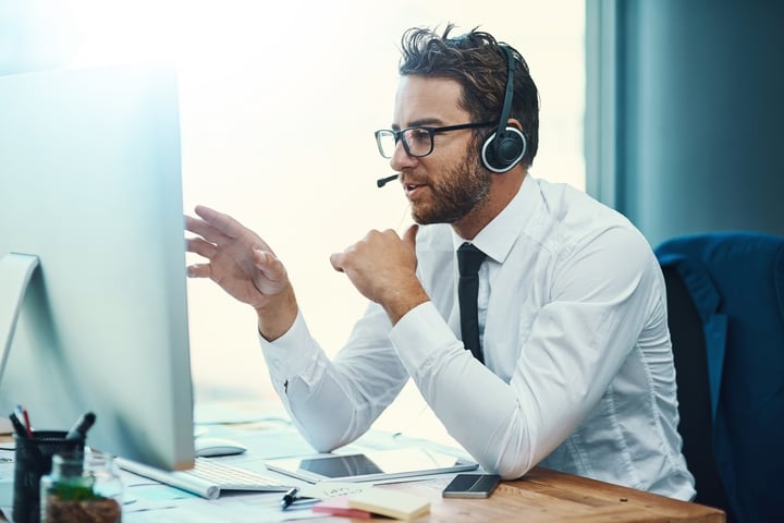 Man with headset on computer